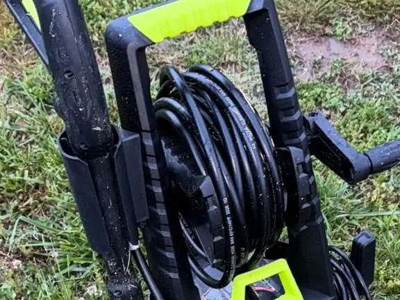 Close-up of stainless steel retractable hose reel guide arm and spring mechanism